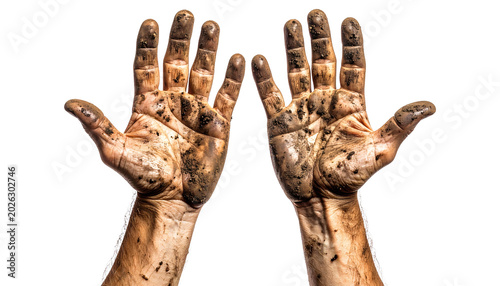 Close up view of a pair of human hands completely covered in dark brown mud and dirt, showing the hard work involved in strenuous manual labor or outdoor gardening  
