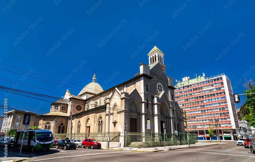 Fototapeta premium St. James Cathedral in Valparaiso, Chile. The historic Gothic Revival stone church stands on a street corner near Avenida Argentina under a clear blue sky