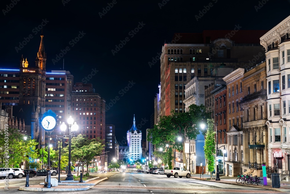 Fototapeta premium Night view down State Street in downtown Albany, New York, flanked by historic architecture and streetlights, United States