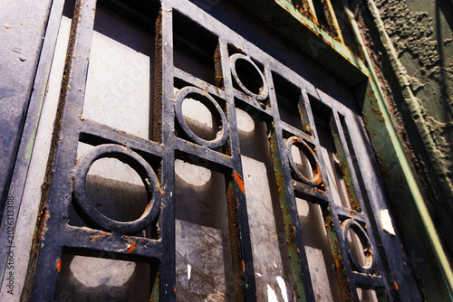 Fotografie Close-up of a rustic, old metal gate with a melancholic mood, showcasing industrial style and weathered texture
