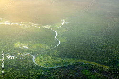 Fotografie Scenic Tributary of the Demerara River Winding through the Amazon Rainforest in
