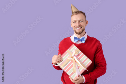 Young man in party hat with...