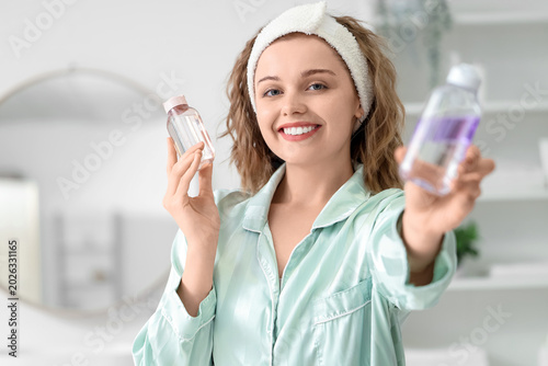 Young woman with bottles of...
