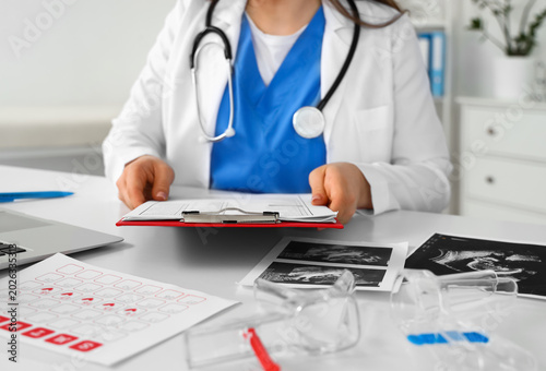 Female gynecologist working...