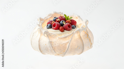 Elegant Pavlova Meringue Dessert with Fresh Berries and Cream on White Background