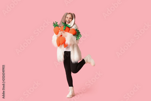 Happy woman in bunny ears w...