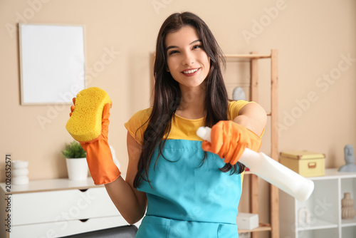 Young woman with sponge and...