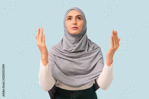 Young Muslim woman praying ...
