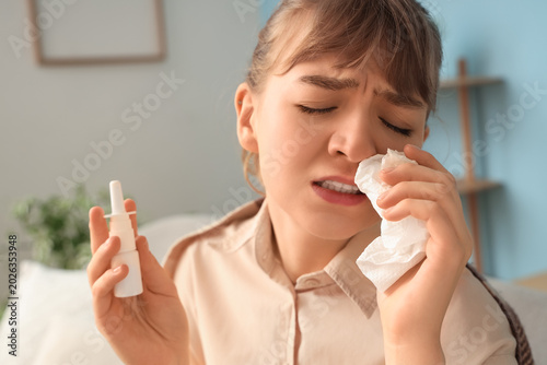Ill young woman with nasal ...