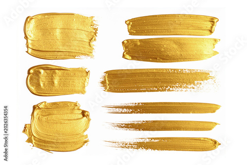 collection of gold paint brush strokes isolated on white background.