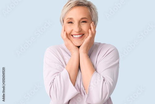 Mature blonde woman on blue...