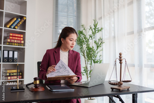 Young asian lawyer woman working on legal document