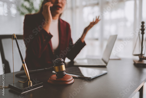 Lawyer woman talking on phone with gavel