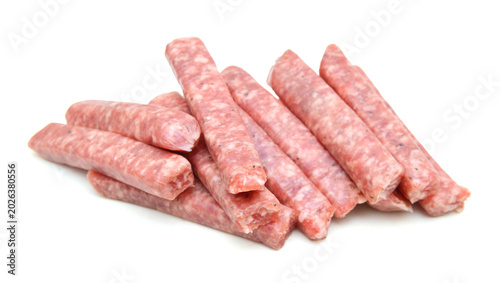 Schilderij op canvas Raw meat sausages isolated on white background