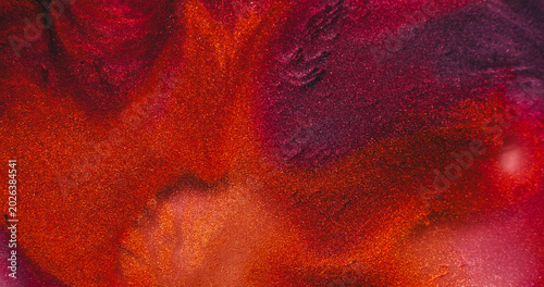 Blend paint. Glitter texture. Defocused pink purple orange colorful chemical droplet liquid leaking on abstract acrylic art background.