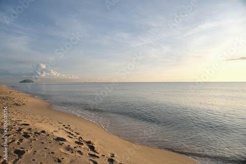 Tranquil tropical beach morning with calm waves at Chalatat, Songkhla