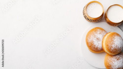 Hanukkah Sufganiyot with Milk in Ornate Gold Cups on White Background