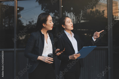 Business people walking and talk to each other in front of modern office