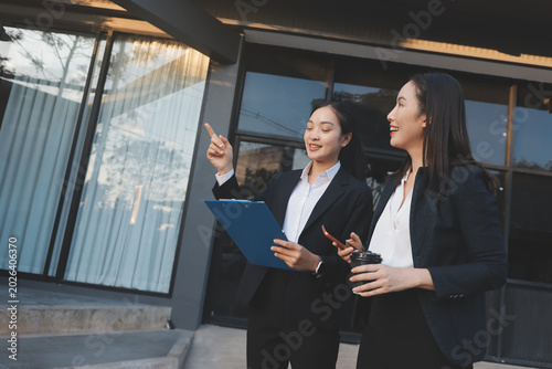 Business people walking and talk to each other in front of modern office