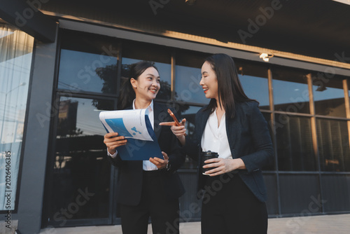 Business people walking and talk to each other in front of modern office