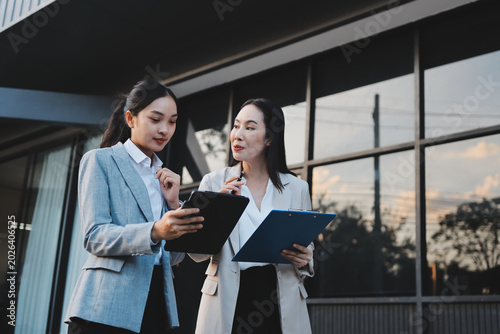 Business people walking and talk to each other in front of modern office