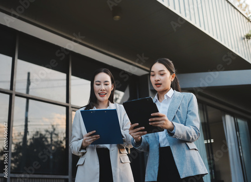 Business people walking and talk to each other in front of modern office