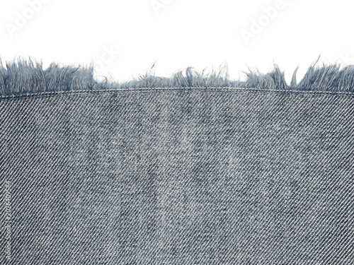 Quadro su tela Close-up of frayed denim fabric edge with detailed threads against a black background