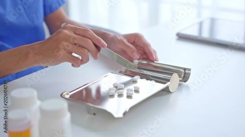 Pharmacist using equipment to dispense medication