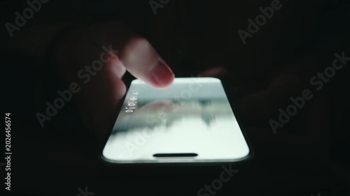 Extreme Closeup Finger Scrolling Smartphone Screen at Night
