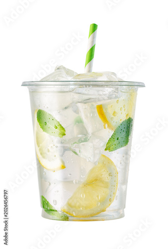 Refreshing lemonade in transparent disposable plastic cup with ice, lemon slices and fresh mint leaves isolated PNG on transparent background