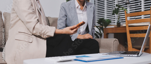 Businesswomen reviewing paperwork in conference room