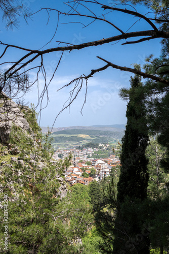 View at the city of Livadia from the top of the mountain at Boeotia-Greece. Blue sky with clouds at the background.