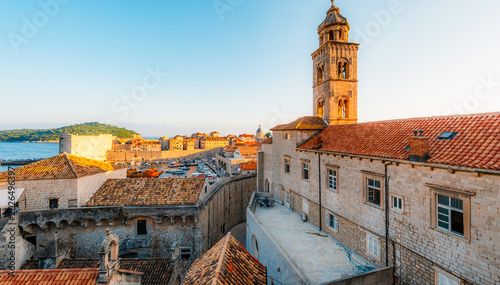 Bild auf Leinwand Golden hour panorama of Dubrovnik's historic fortifications and old port at dusk