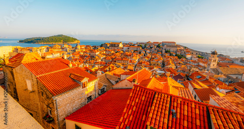 Billede på lærred Golden hour panorama of Dubrovnik's historic fortifications and old port at dusk