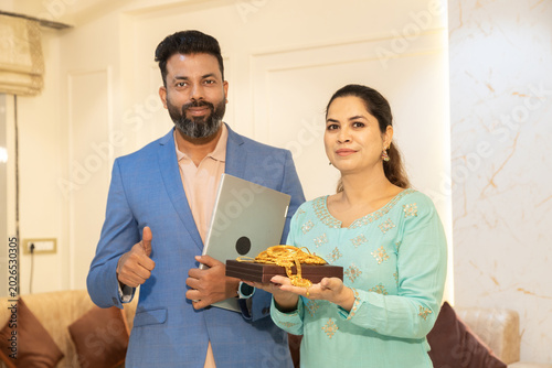 Indian woman holding gold jewellerystanding with bank executive or financial agent for secure lending and personal loan, financial assistance, collateral, investment, and consumer banking services.