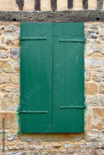 Green Painted Window Shutters on Medieval Stone Wall in French Village