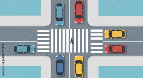 Aerial view of a crosswalk with moving cars and walker