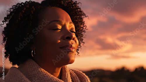 Woman gazing at sunset sky highlighting geometric patterns and contemporary art