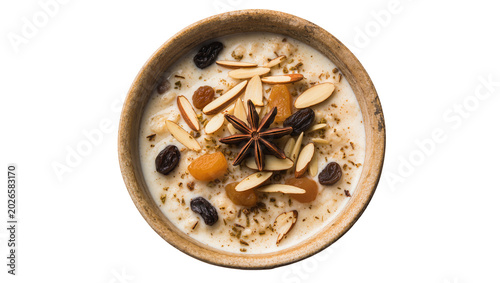 Foto Creamy rice pudding with dried apricots raisins almonds and star anise, isolated