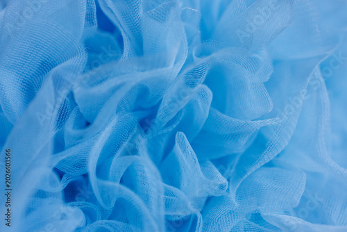 Fotografie Abstract blue ruffled tulle fabric texture background