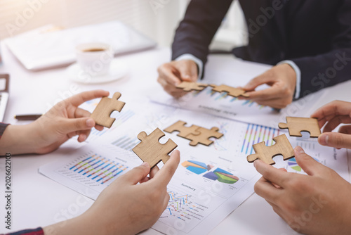 Top view close up shot of professional successful group of  Hand holding jigsaw puzzles, Business partnership concept. Business teamwork with puzzle togetherness collaboration.