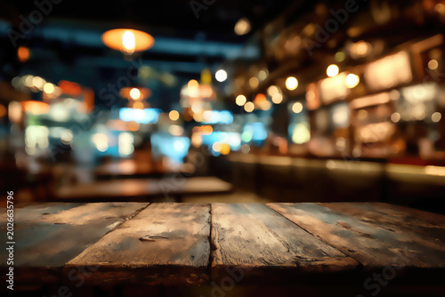 Rustic wooden table in a warm, softly lit, blurred restaurant interior