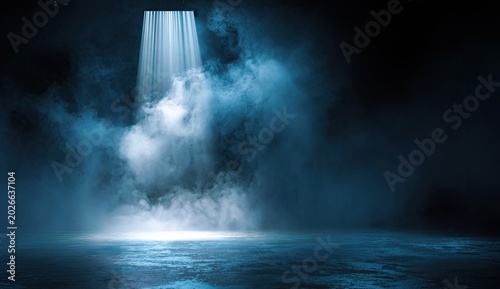 Dramatic blue spotlight pierces through thick atmospheric smoke on a dark stage