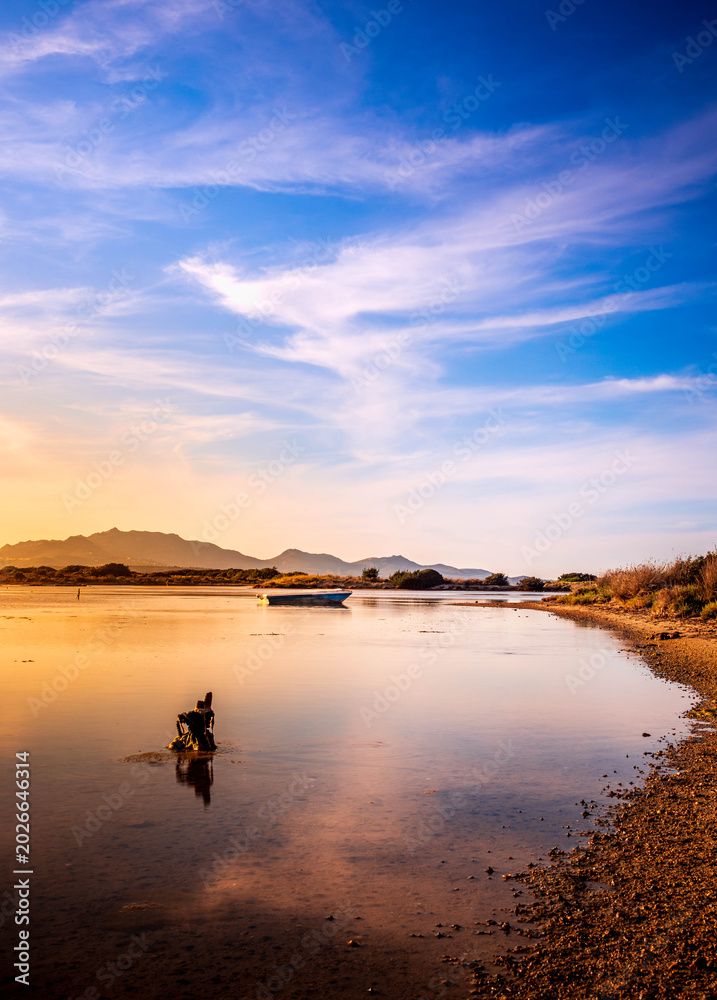 Fototapeta premium Fishermen''s boats in a bay in the sunset
