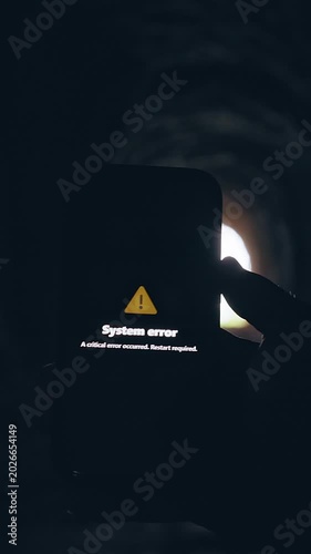 Vertical video. Smartphone Displaying System Error Message Inside Dark Tunnel, Cinematic Technology Failure Scene About Digital Malfunction and Communication Breakdown