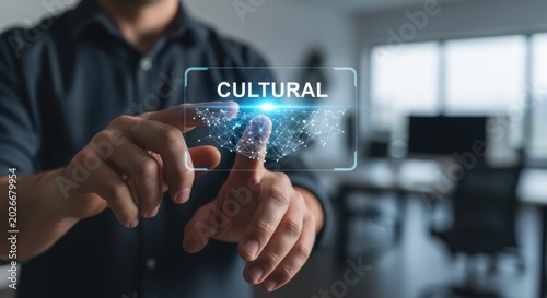 Businessman touching digital holographic interface with word cultural, for global connectivity, social diversity, heritage preservation, international business growth