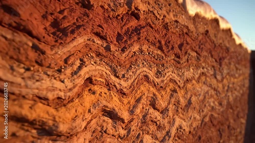 Layered red soil with rocks emphasizing sleek aesthetics and strong visual impact