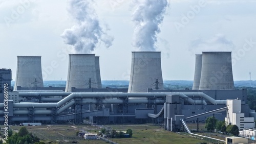 Schilderij op canvas This high-resolution aerial photograph captures a large thermal power plant with its characteristic hyperbolic cooling towers prominently featured