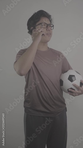 Southeast Asian people call their friends while carrying ball, inviting them to watch football. S-Log3, S-Gamut3.Cine