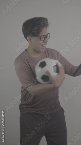 Southeast Asian person watch football on their tablets, then rejoice when their team scores goal S-Log3, S-Gamut3.Cine